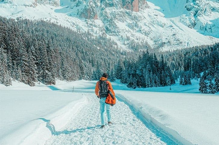 Man in mountains in snow travel destination