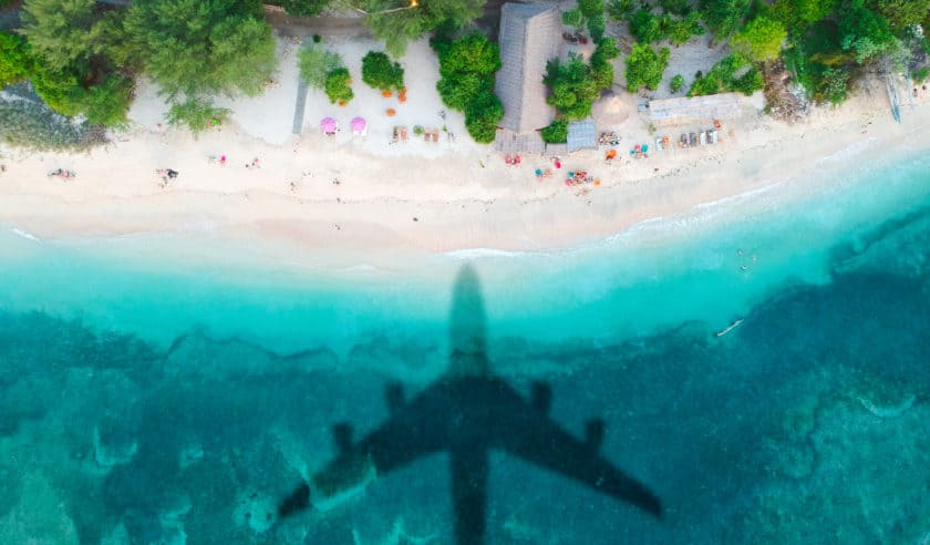 Plane flying over beach